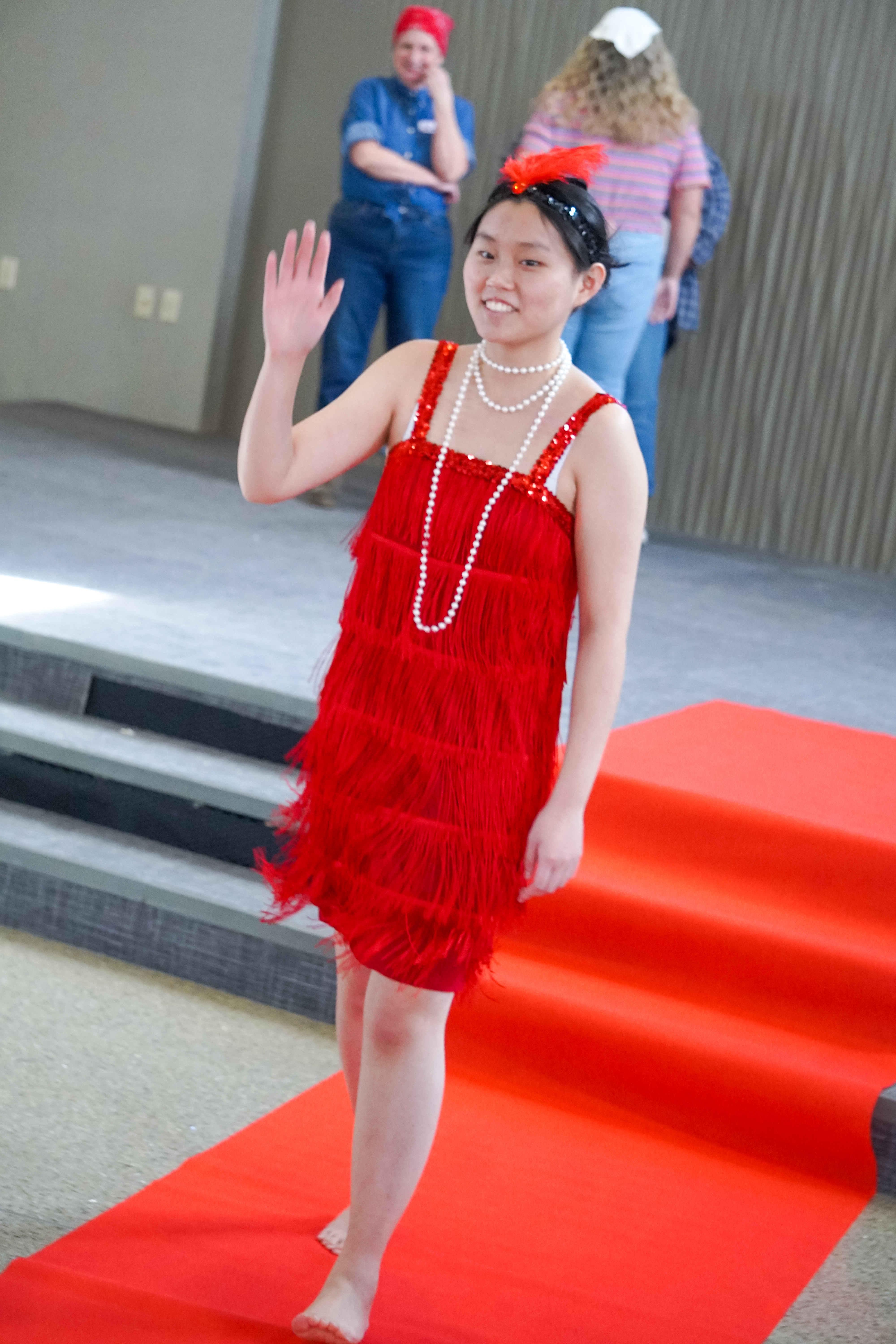 A female student wearing a flapper-inspired dress and ensemble