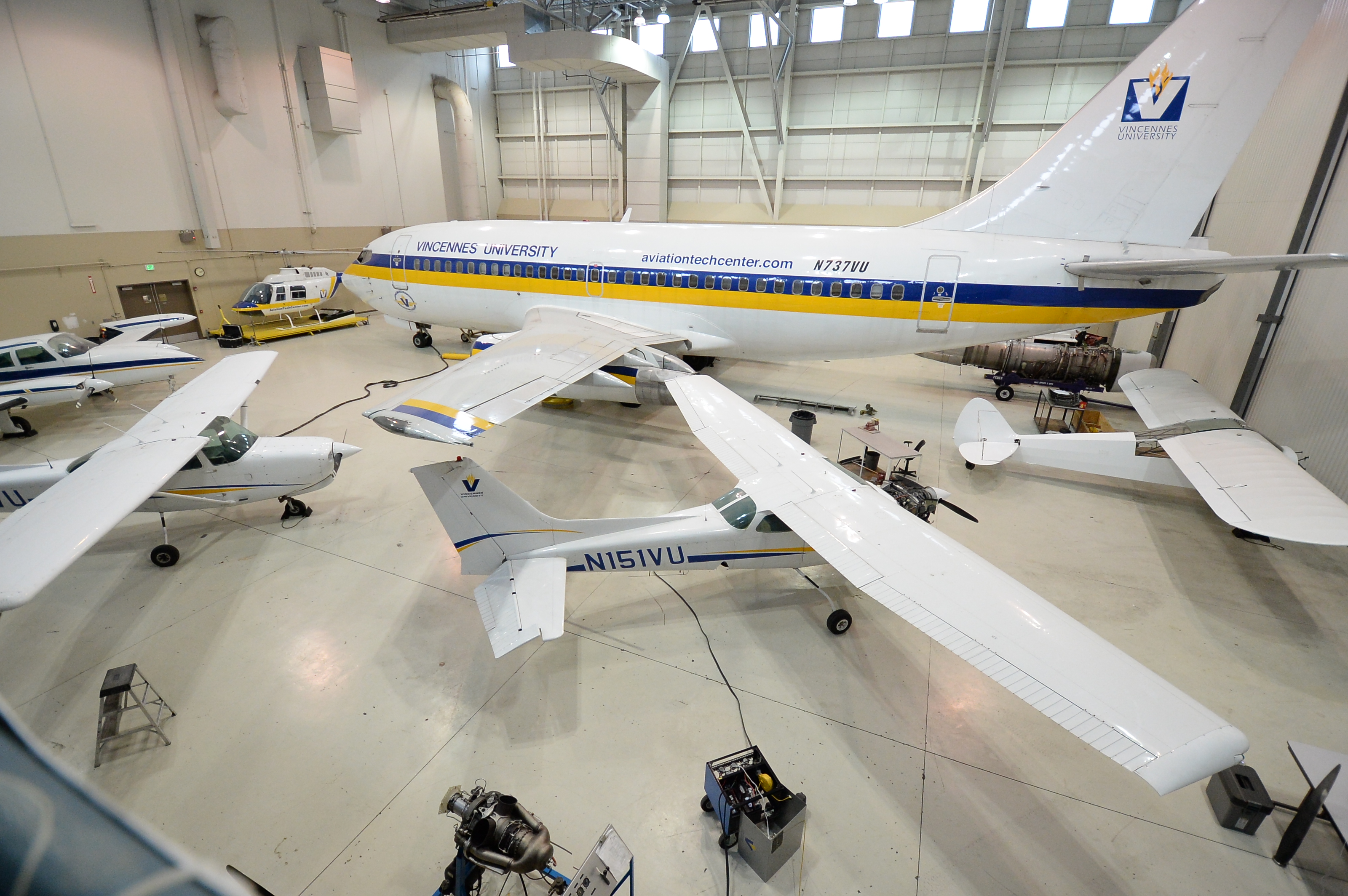 Multiple VU aircraft including a 737, helicopter and more in a hangar at the VU Aviation Technology Center in Indianapolis.